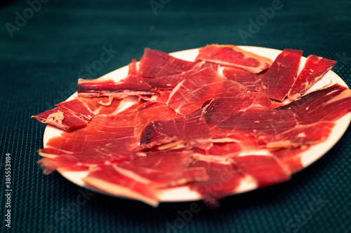 white plate with slices of Serrano ham. Typical Spanish