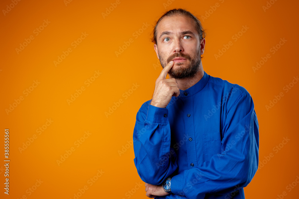 Confused bearded young man thinking about something Confused bearded young man thinking about something