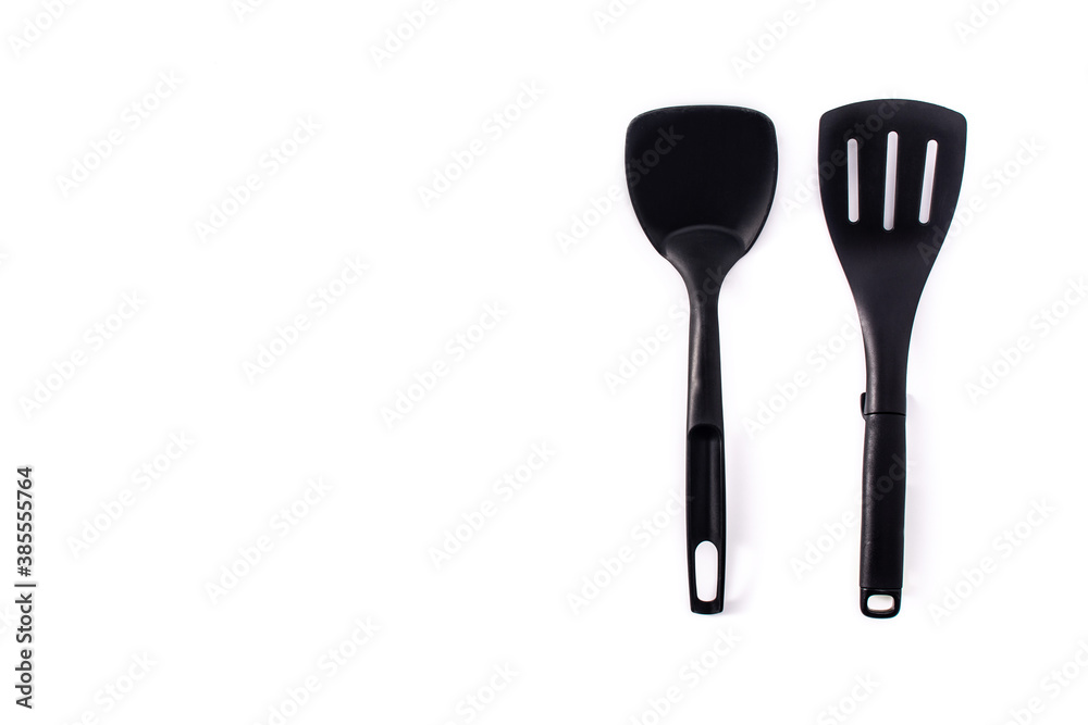 Black plastic kitchen spatula and spoon isolated on white background.Copy space Black plastic kitchen spatula and spoon isolated on white background.Copy space