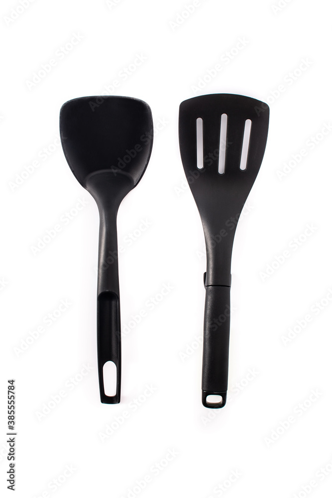 Black plastic kitchen spatula and spoon isolated on white background Black plastic kitchen spatula and spoon isolated on white background