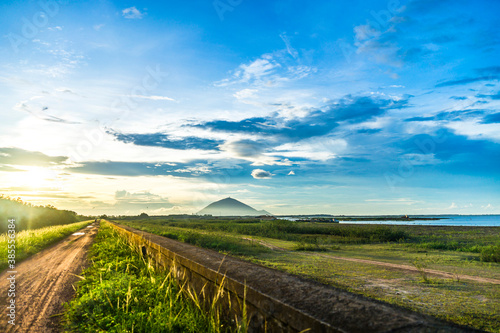 View of beautiful sunset with blue sky in Dau Tieng lake, Tay Ninh province, Vietnam. photo