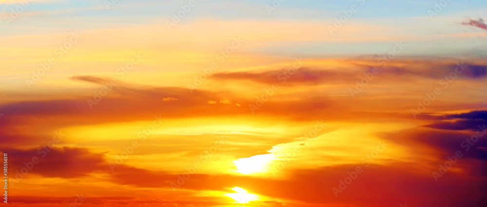 scenic sunset sky landscape background natural color of evening cloudscape panorama with setting sun and dark clouds ultra wide panoramic wallpaper