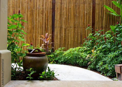 Home decoration - small garden with pathway, water jar, and bamboo wall Fototapeta