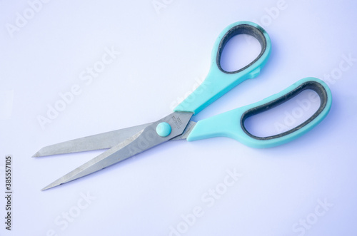 A pair of stainless steel scissors on a white background.