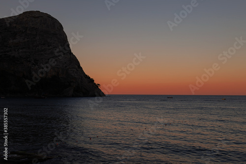 seascape with mountains at sunset