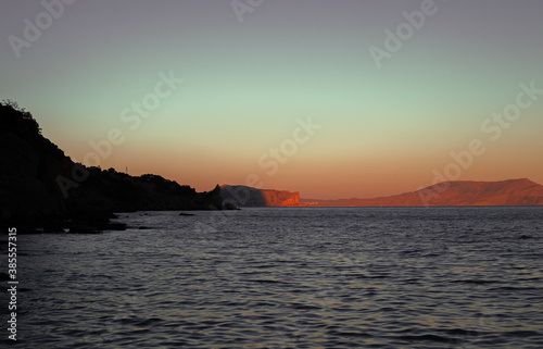 seascape with mountains at sunset
