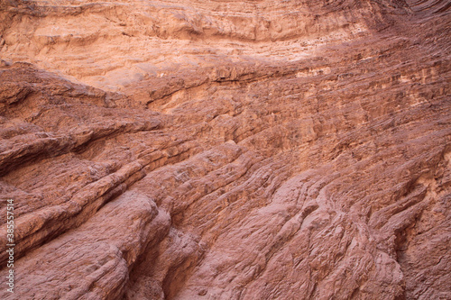 Geology. Natural texture and pattern. Closeup view of the red sandstone and rocky formation in the desert.