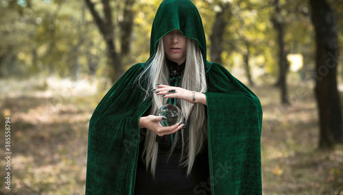 Fotografie Mystical scene at forest, wizard look, Halloween ideas, magic costume