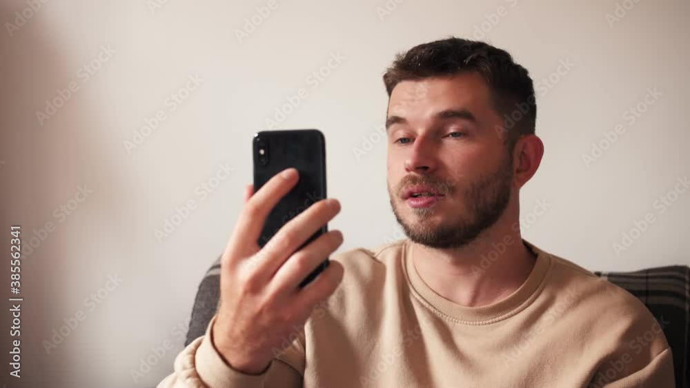 man with smartphone having video call at home man with smartphone having video call at home