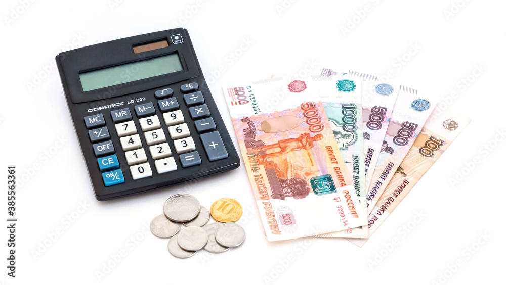 calculator and russian money banknotes and coins on white background. Isolated. calculator and russian money banknotes and coins on white background. Isolated.