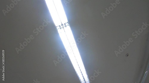 Medical corridor ceiling lights seen from below emergency patient`s perspective looking up