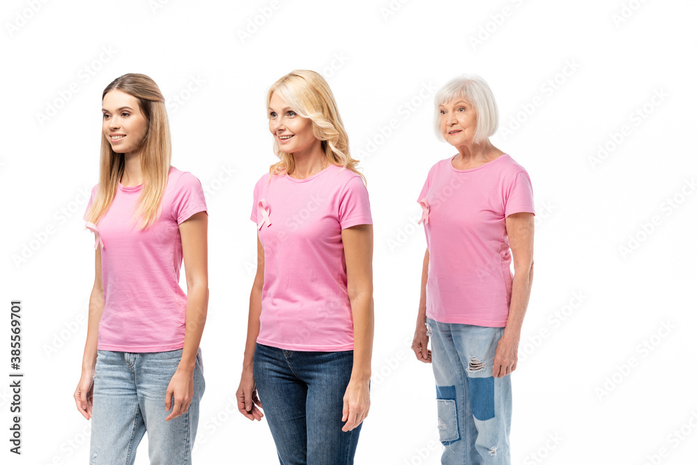 Fototapeta premium Women with breast cancer awareness ribbons looking away isolated on white