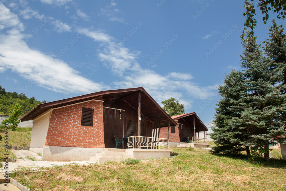 Wooden bungalows and garden in the forest. Holiday apartmens Wooden bungalows and garden in the forest. Holiday apartmens