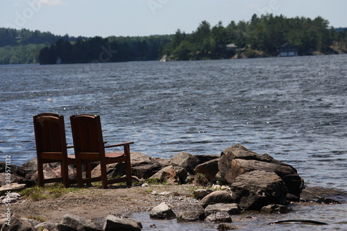 empty chairs by the lake