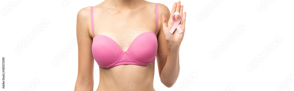 Panoramic shot of woman in bra holding ribbon of breast cancer awareness isolated on white