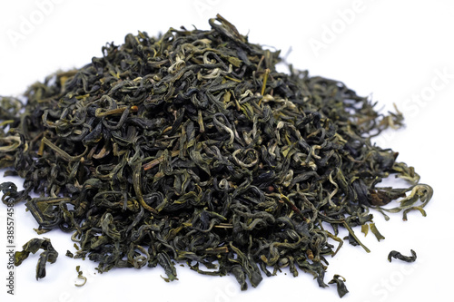 dry green tea leaves on a white background. green chinese tea close up. high quality tea for health.