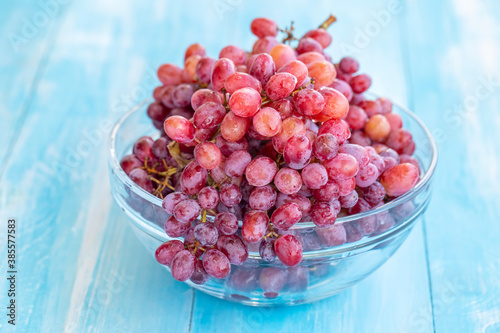 Fresh red grapes on the blue background
