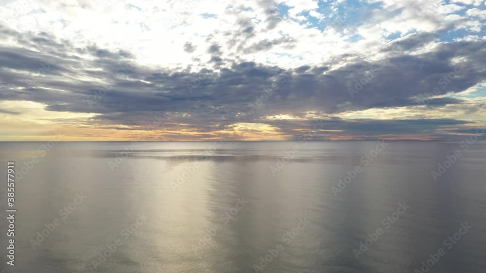 AERIAL: Ascending Pedestal Shot of Horizon and Cumulus Cloudy Sky with Calm Baltic Sea AERIAL: Ascending Pedestal Shot of Horizon and Cumulus Cloudy Sky with Calm Baltic Sea