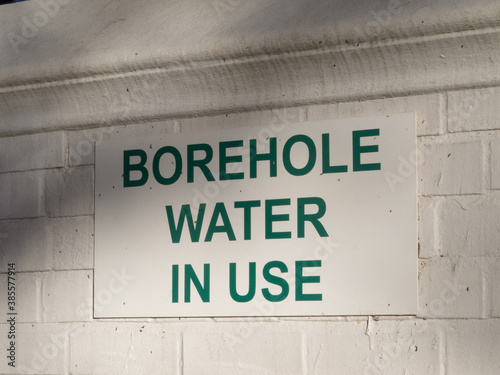 sign on a wall with words or text borehole water in use concept drought in South Africa