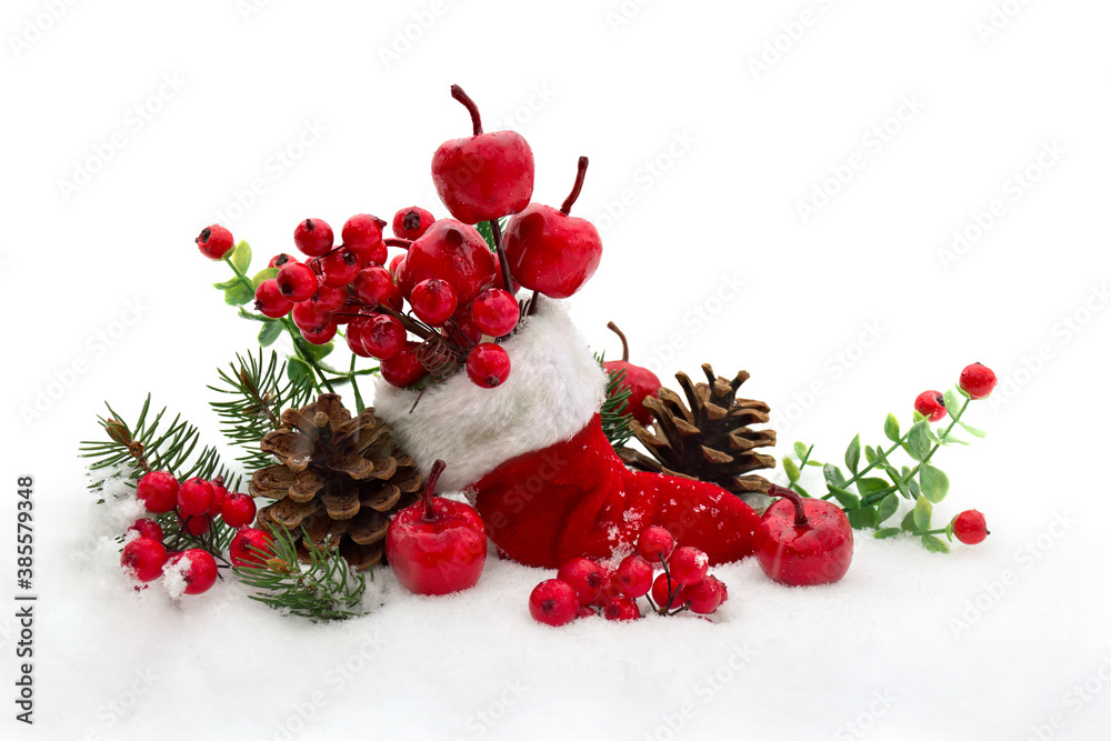 Christmas decoration. Stocking with red berries and apples, twigs christmas tree, cones pine on snow with space for text