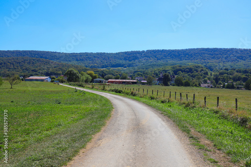 View of a french rural country road at summer on a sunny and warm day. © Johan