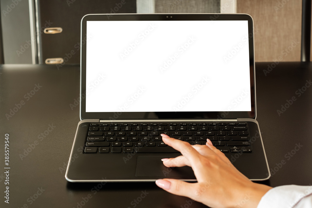 Freelance work. Online training. Digital technology. Distance cooperation. Female hand scrolling touch pad on laptop blank screen workplace interior copy space.