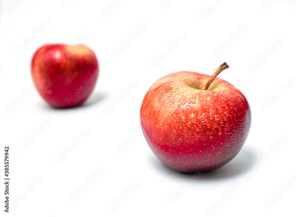 Two apples isolated. Sweet delicious dessert. Side view. With water drops. Partial blur. Two apples isolated. Sweet delicious dessert. Side view. With water drops. Partial blur.