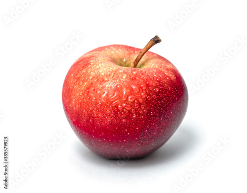Fresh red apple isolated on white. Sweet delicious dessert. Side view. With water drops.