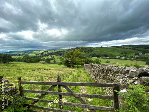 Landscape view, with heavy cloud, dry stone walls, fields, and meadows near, Barden, Skipton, UK