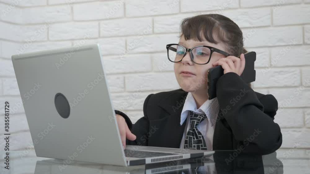 Girl operator. A busy little boss work on computer and speak on telephone in the room. Girl operator. A busy little boss work on computer and speak on telephone in the room.
