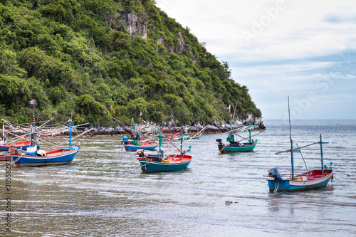 Small fishing boats made from wood on the beach Fishing boats in the sea in Thailand