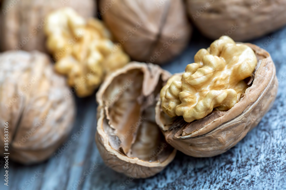 Ripe and raw whole big walnut kernel with thin shell on wooden rustic backdrop. Healthy nut food for brain. Fresh walnuts background concept Ripe and raw whole big walnut kernel with thin shell on wooden rustic backdrop. Healthy nut food for brain. Fresh walnuts background concept