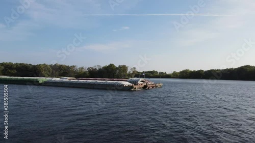 Close up of a large barge transporting cargo containers down the Mississippi river in La Crosse, Wisconsin. photo