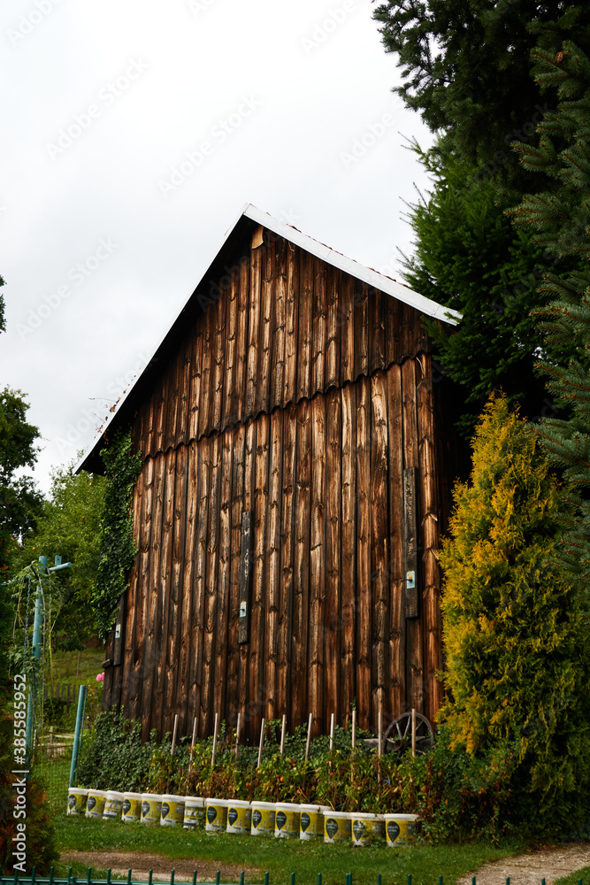 Naklejka premium 20200927 Reconstructed barn near the dam as a suitable place for growing tomatoes