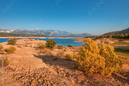 Karacaoren is a dam pond on the Aksu river in Turkey near the city of Antalya. A popular place for recreation and fishing. Panoramic view of the lake and the Taurus mountains at sunset