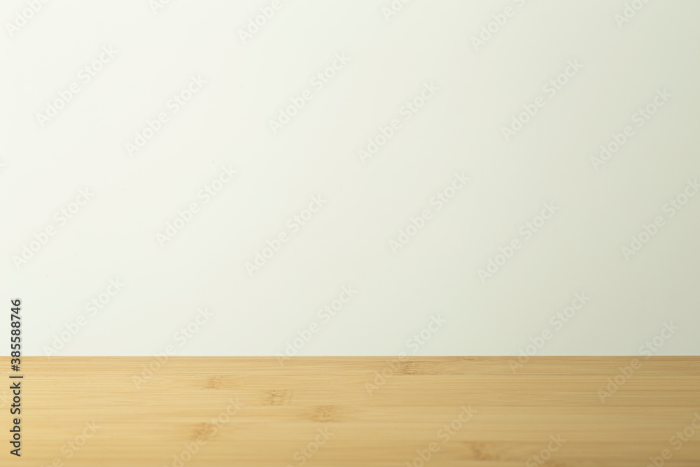 Empty wooden table with white background. Light background with a table for objects and labels.