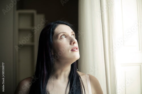 portrait of girl looking out the window