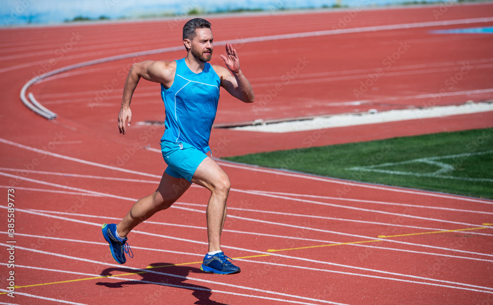 Fototapeta premium Dynamic movement of male runner on running track, run