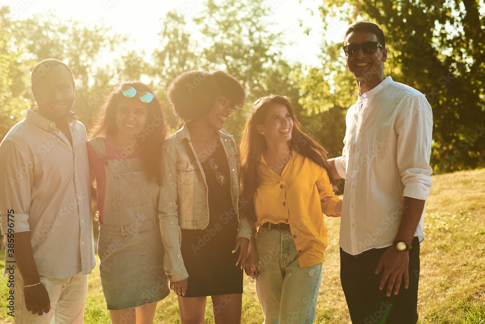Group of happy friends having fun outdoor. Young diverse culture people and friendship concept Group of happy friends having fun outdoor. Young diverse culture people and friendship concept