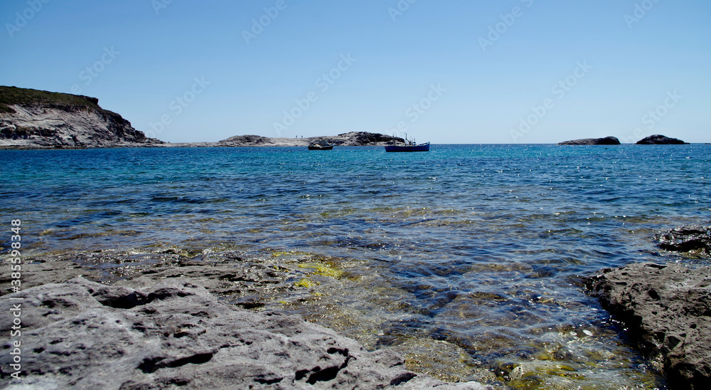 Stony beach and rocks on the coastline with a view on blue sea in sunny day in Sardinia. Stony beach and rocks on the coastline with a view on blue sea in sunny day in Sardinia.