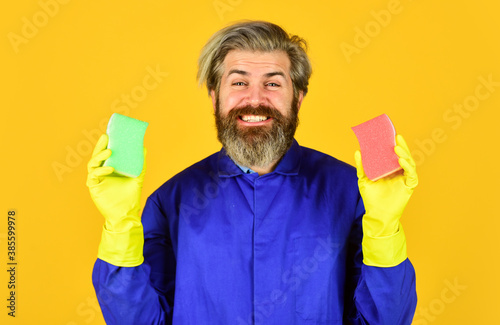 Clean home. Protection. Man wear protective rubber gloves. Bearded cleaner in blue uniform. Spring cleaning. Hipster clean house. Disinfection concept. Virus and microbe removal. Virus disinfection