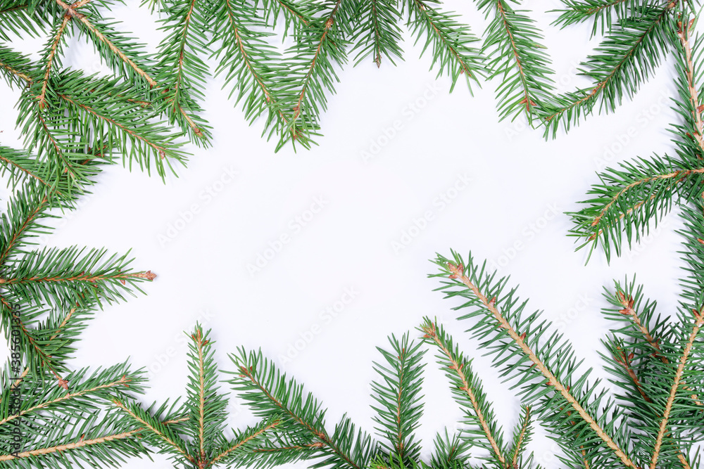 Christmas festive decor on a white background, Fir branches. Free space for text. Flat lay.