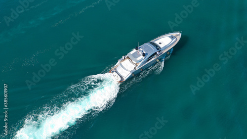 Aerial drone photo of small luxury yacht with wooden deck cruising near tropical exotic port © aerial-drone