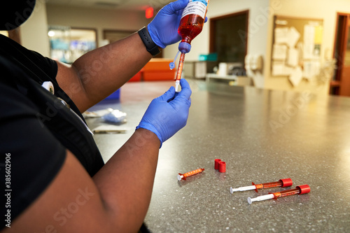 Black pharmacist prepare medication for hospital patient