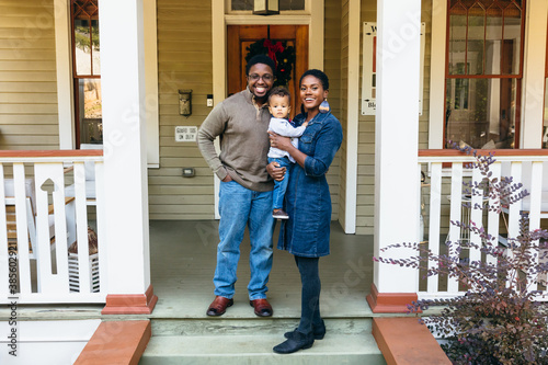 Potrait of black family and child in front of home for the holidays