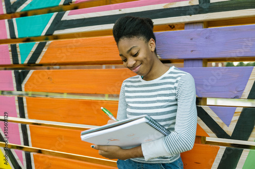 Young Black teen female studying art at school