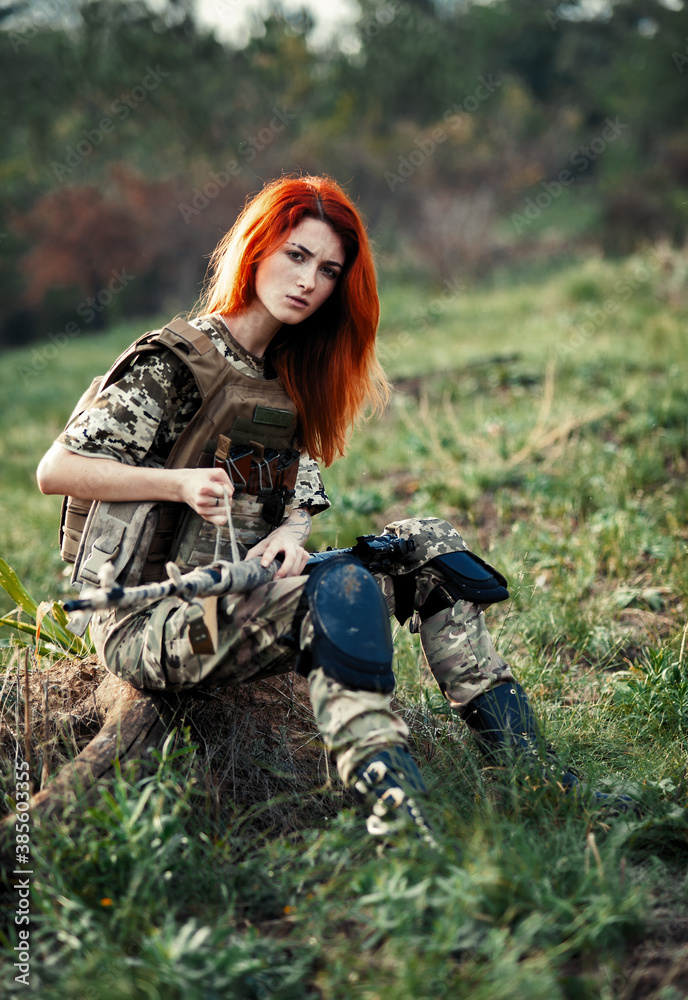 © Omeliyen - Sniper girl in a green field. Military snipers. The sniper smokes. Red-haired girl in camouflage. Fighting © Omeliyen - Sniper girl in a green field. Military snipers. The sniper smokes. Red-haired girl in camouflage. Fighting