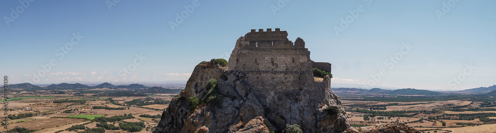 Panorama of mountains and fields in Sardinia, Italy and old castle view. 