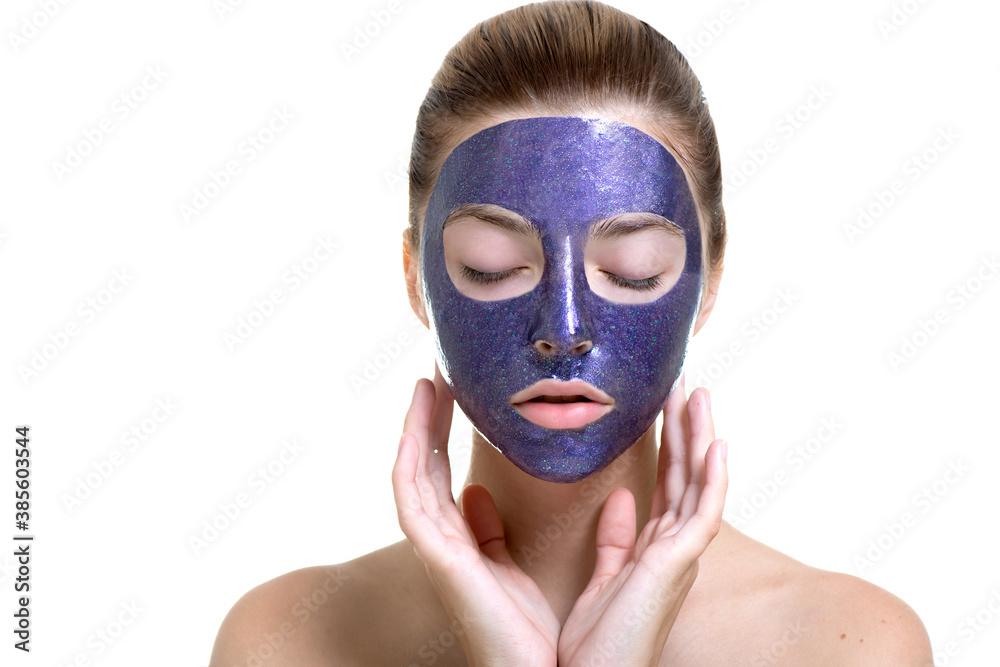 Young woman with violet shiny glamor face mask on her face. Young woman with violet shiny glamor face mask on her face.