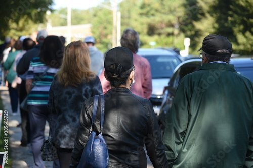 Принти на полотні North Carolina voters stand in very long lines to cast their ballots on the first day of early voting